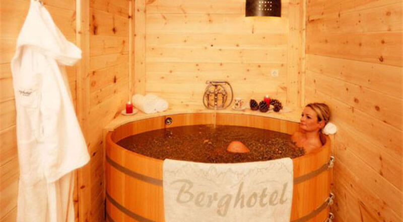 Relaxing mountain blossom bath in a wooden tub
